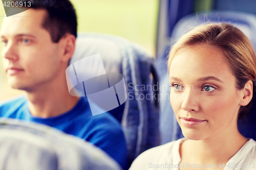 Image of happy young woman sitting in travel bus or train