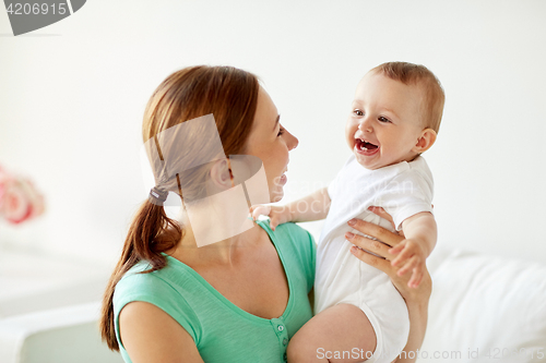 Image of happy young mother with little baby at home