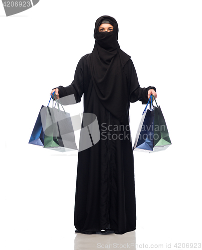 Image of muslim woman in hijab with shopping bags