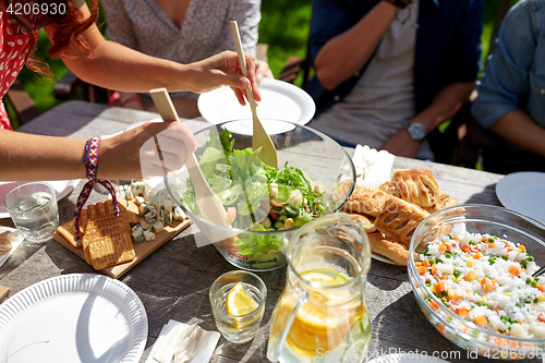 Image of friends having dinner at summer garden party