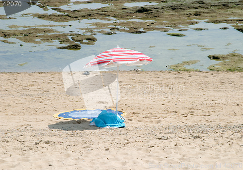 Image of Beach umbrella and towel in the bay of Cadiz, Andalusia, Spain