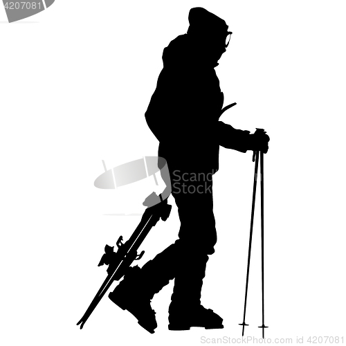 Image of Skier standing on the snow and keeps skis. sport silhouette