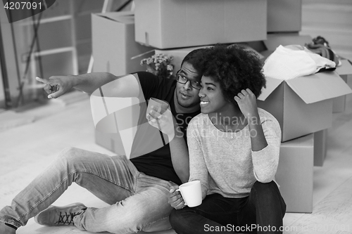 Image of African American couple relaxing in new house