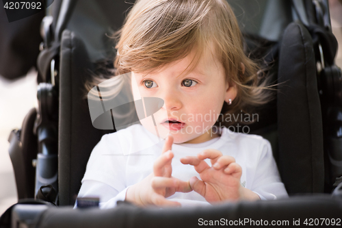 Image of baby girl sitting in the pram