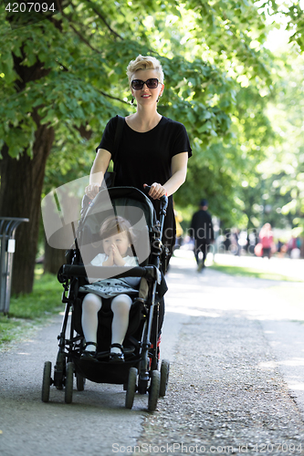 Image of mother pushed her baby daughter in a stroller