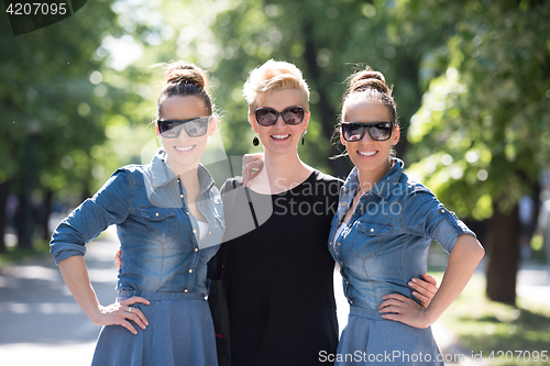 Image of portrait of three young beautiful woman with sunglasses