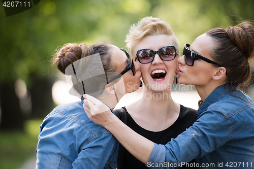 Image of portrait of three young beautiful woman with sunglasses