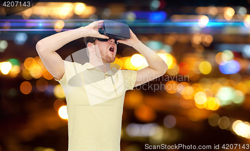 Image of happy man in virtual reality headset or 3d glasses