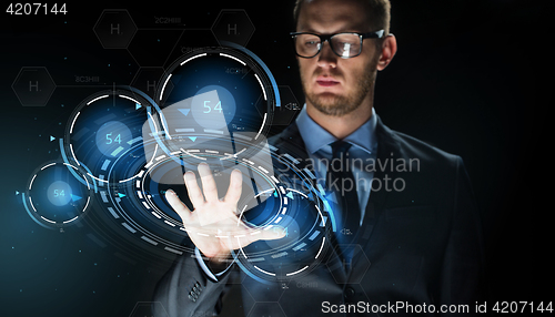 Image of businessman touching virtual projection