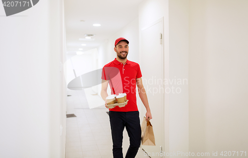 Image of man delivering coffee and food to customer home