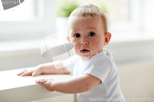 Image of happy little baby boy or girl at home