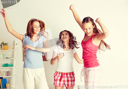 Image of happy friends or teen girls having fun at home