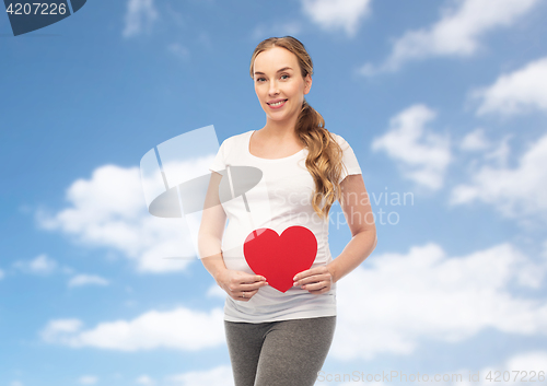 Image of happy pregnant woman with red heart
