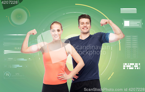 Image of happy sportive man and woman showing biceps power