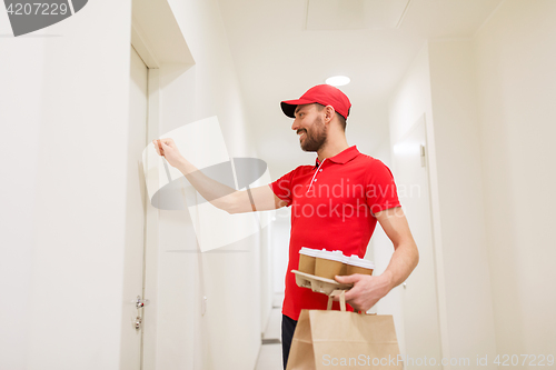 Image of delivery man with coffee and food knocking on door