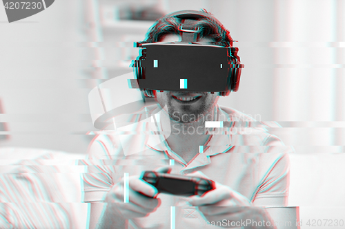 Image of man in virtual reality headset with controller