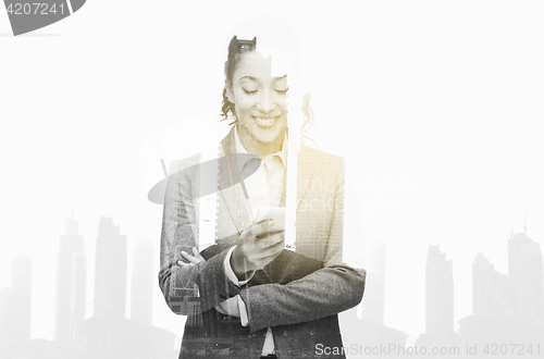 Image of smiling businesswoman looking at smartphone