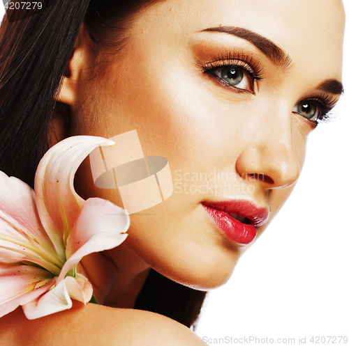 Image of young attractive lady close up with hands on face isolated flowe