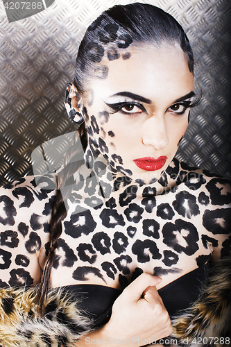 Image of young sexy woman with leopard make up all over body, cat bodyart