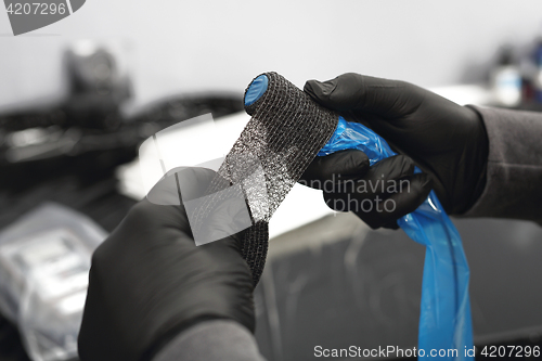 Image of Securing the machine stretch film. Hygiene and prevention tattoo parlor.