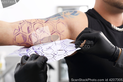 Image of Color tattoo. Tatoo drawing on his shoulder.