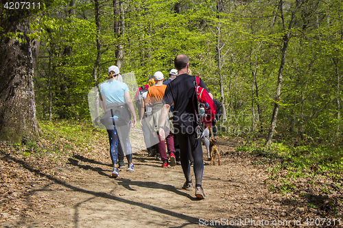 Image of Group of people walking by hiking trail