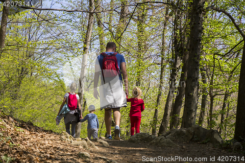 Image of Parents with children walking by hiking trail