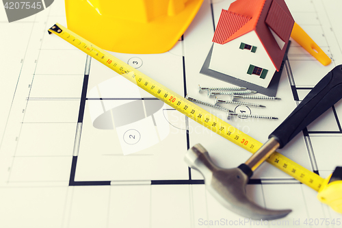 Image of close up of house blueprint with building tools