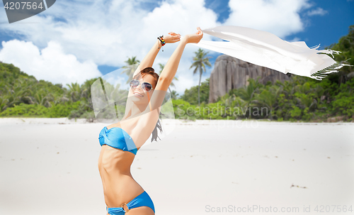 Image of woman in bikini and sunglasses with pareo on beach