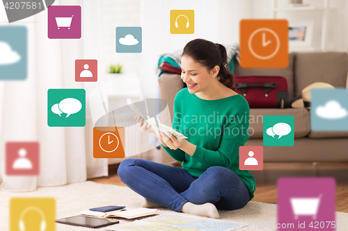 Image of happy woman with money and travel map at home