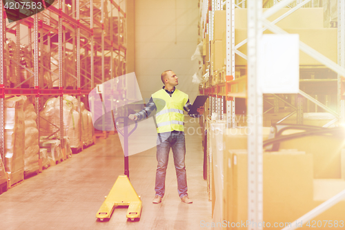 Image of man with loader and clipboard at warehouse