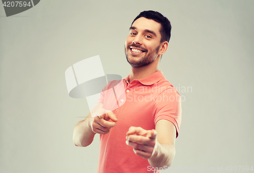 Image of man pointing finger to you over gray background