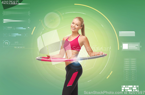 Image of young sporty woman with hula hoop