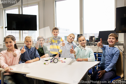 Image of happy children building robots at robotics school