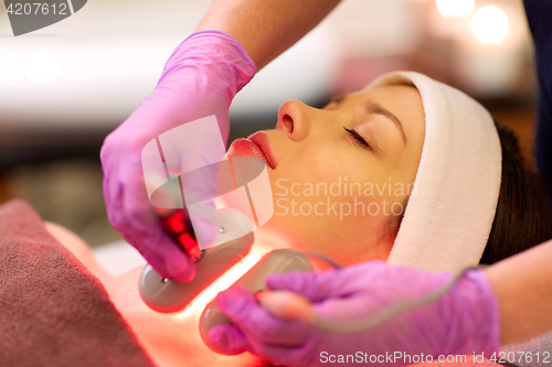 Image of young woman having face microdermabrasion at spa