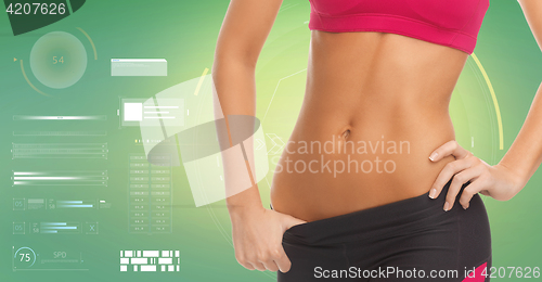 Image of close up of sporty woman abdomen over green