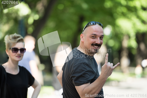 Image of man showing a rock hand gesture