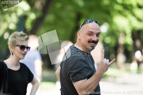 Image of man showing a rock hand gesture