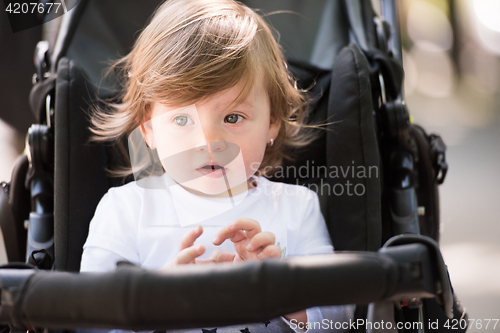 Image of baby girl sitting in the pram