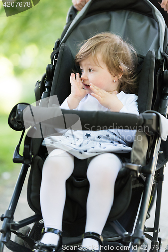 Image of mother pushed her baby daughter in a stroller