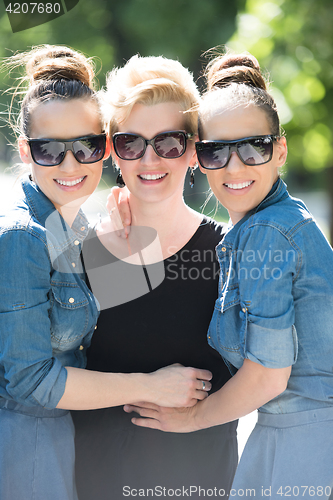 Image of portrait of three young beautiful woman with sunglasses