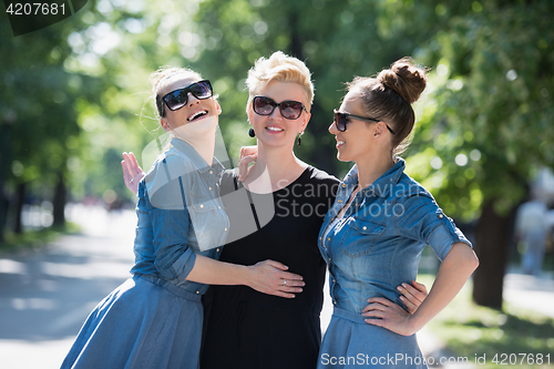 Image of portrait of three young beautiful woman with sunglasses