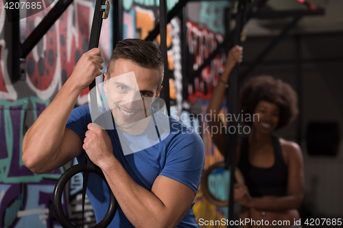 Image of Portrait of multiethnic couple  after workout at gym