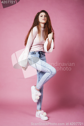 Image of young pretty red hair ginger girl jumping isolated on pink background, lifestyle flying teen people happy smiling concept 