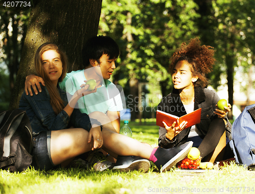 Image of cute group of teenages at the building of university with books 