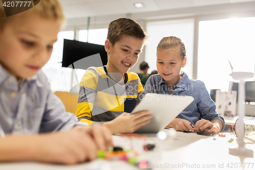 Image of kids with tablet pc programming at robotics school