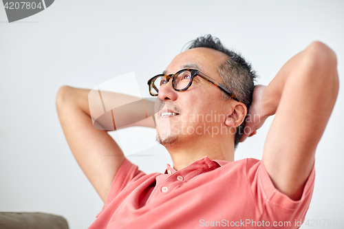 Image of man in glasses relaxing or dreaming at home