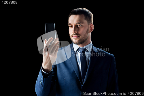 Image of businessman with transparent smartphone