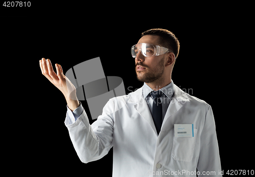 Image of doctor or scientist in lab coat and safety glasses