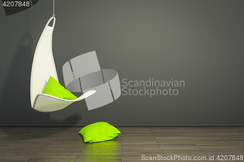 Image of hanging armchair with green pillows